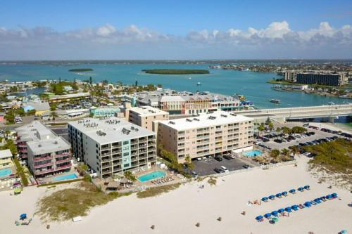an aerial view of a resort with a beach and water at 103 - Sandy Shores in St. Pete Beach