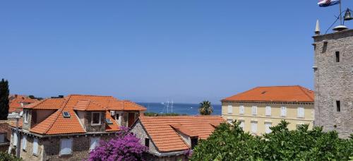a view of roofs of buildings and a tower at Apartmani Neva Supetar in Supetar