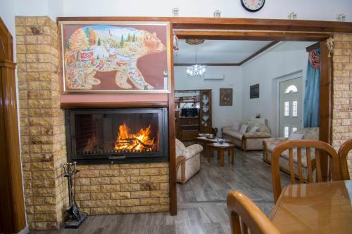 a living room with a fireplace with a painting of a dog at Paradise House with Private Pool in Kissamos