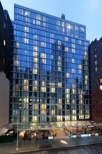 a large glass building with lights on at INNSiDE by Meliá New York Nomad in New York