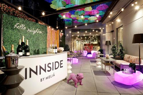 a wine store with pink furniture and wine bottles at INNSiDE by Meliá New York Nomad in New York