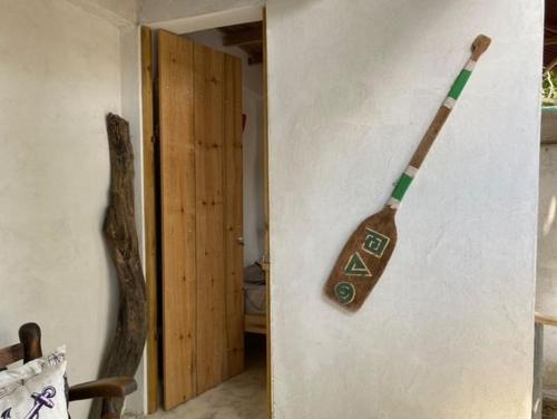a broom hanging on a wall in a room at Jumanji in Palomino