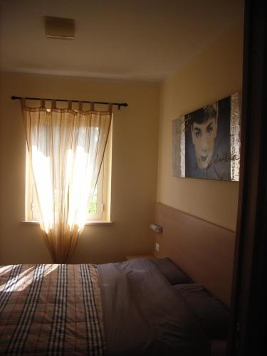 a bedroom with a bed and a window at Marasusa in Parghelia