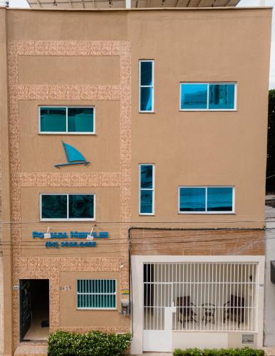 a building with blue benches in front of it at Pousada Meireles in Fortaleza