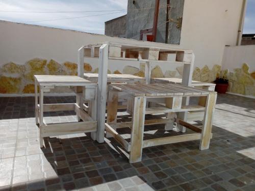 a wooden bunk bed with two stools on a floor at Appartamento L'Ammiraglio in Trapani