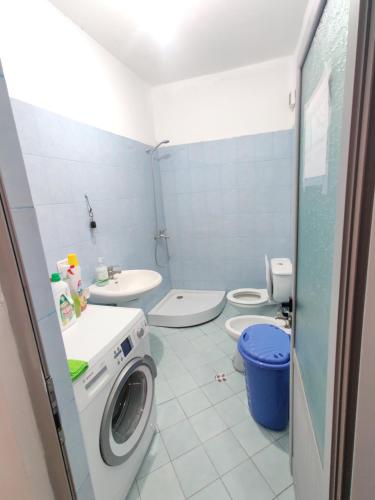 a bathroom with a washing machine and a toilet at Home sweet Home 2 - Guest House in Tirana