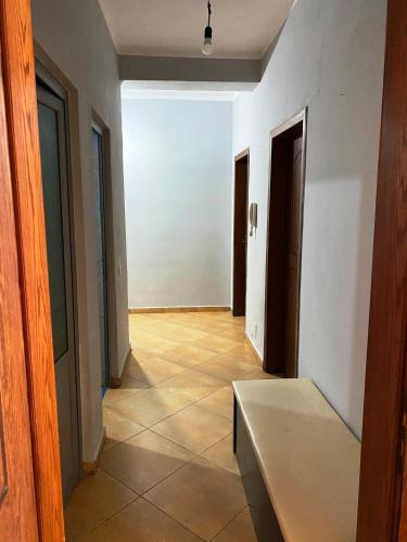 a hallway with a bench in the middle of a room at Home sweet Home 2 - Guest House in Tirana