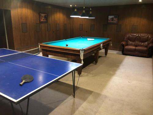 a pool table in a room with two ping pong tables at Armenia villa Jrvezh in Dzoraghpʼyur