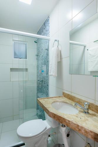 a bathroom with a toilet and a sink and a shower at Pousada Meireles in Fortaleza