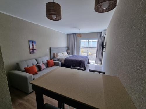 a living room with a couch and a bed at Casa de Playa in Necochea
