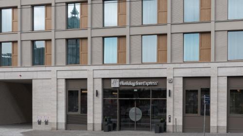 a building with a sign on the front of it at Holiday Inn Express & Suites - Potsdam by IHG in Potsdam