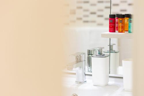 a bathroom with a sink with a toothbrush holder at Hotel Edelweiss Riccione in Riccione