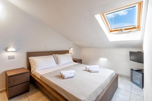 a bedroom with a bed and a skylight at Hotel Edelweiss Riccione in Riccione