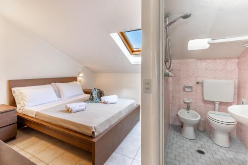 a bedroom with a bed and a shower and a toilet at Hotel Edelweiss Riccione in Riccione