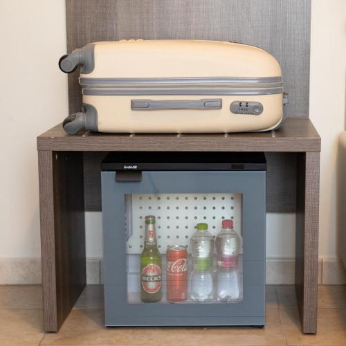a suitcase sitting on top of a table with drinks at Hotel Edelweiss Riccione in Riccione