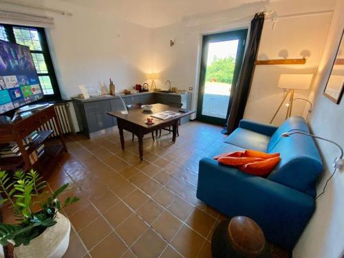 a living room with a blue couch and a table at La Fornace in Alessandria