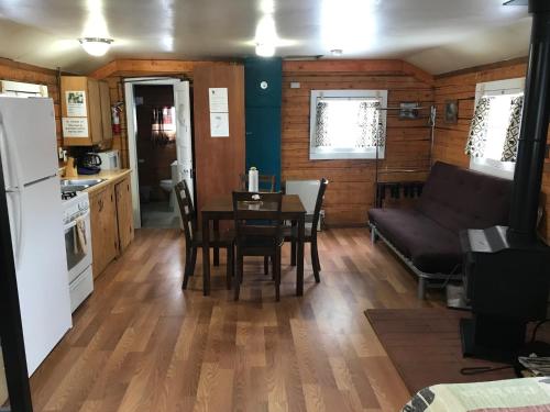 a kitchen and living room with a table and a couch at Grandview Cabins & RV Resort in South Fork