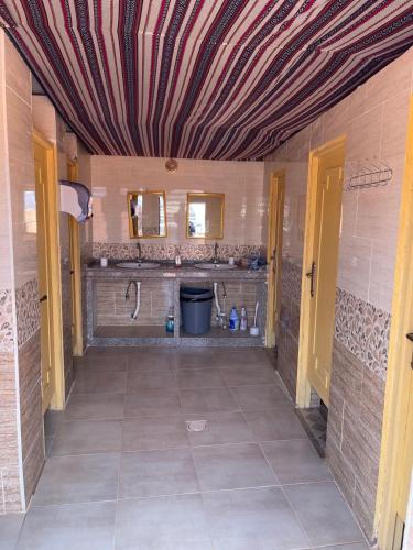 a room with a bathroom with a shower and a sink at Wadi Rum Starlight Camp in Wadi Rum