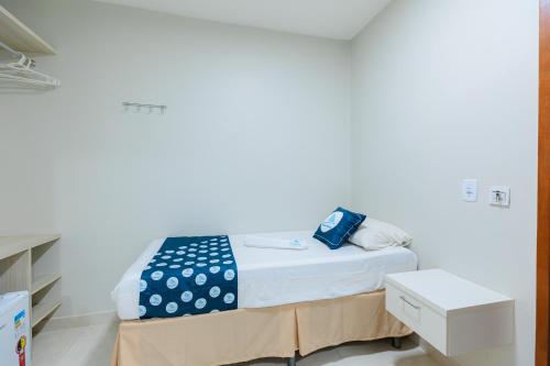 a small bed in a room with a white wall at Pousada Meireles in Fortaleza