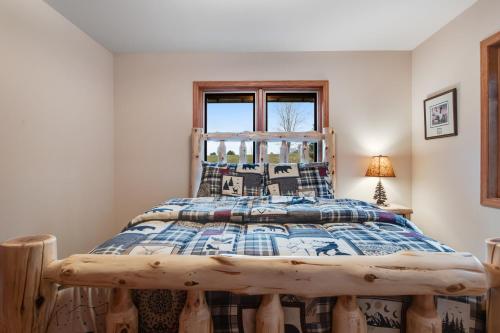 a bedroom with a bed with a wooden frame at GolfView GetAway in Eagle River