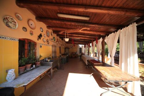 a room with benches and tables in a building at Azienda Agrituristica Seliano in Paestum