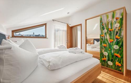 a white bedroom with a large painting on the wall at Schmuckstück Ferienapartments Bodenmais in Bodenmais