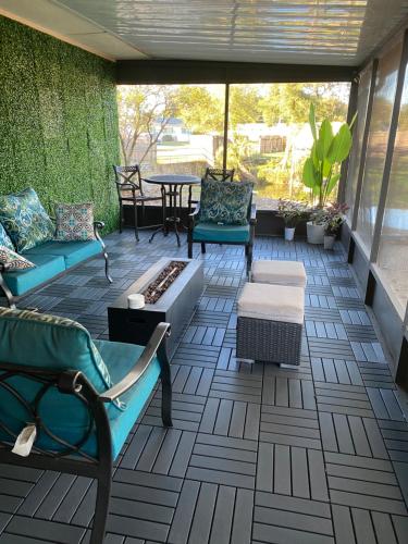 a patio with couches and a table and chairs at Sweet dreams private room across from the Hard Rock Casino in Tampa
