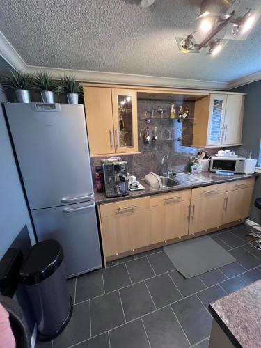 a kitchen with a refrigerator and a sink at Gleneagles Lettings in Auchterarder