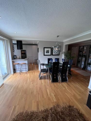 a dining room and living room with a table and chairs at Gleneagles Lettings in Auchterarder