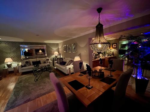 a living room with a dining table and a couch at Gleneagles Lettings in Auchterarder