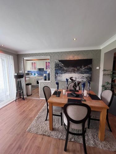 a dining room with a table and chairs at Gleneagles Lettings in Auchterarder
