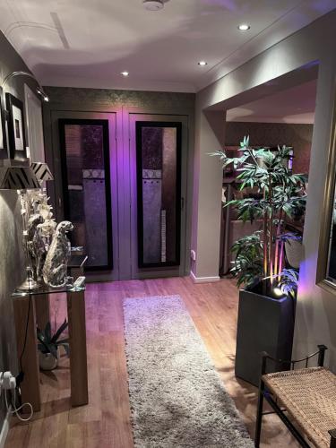 a purple door in a room with a potted plant at Gleneagles Lettings in Auchterarder