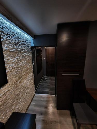 a room with a hallway with a brick wall at Luxury apartaments Klimatyzacja 1 in Radom