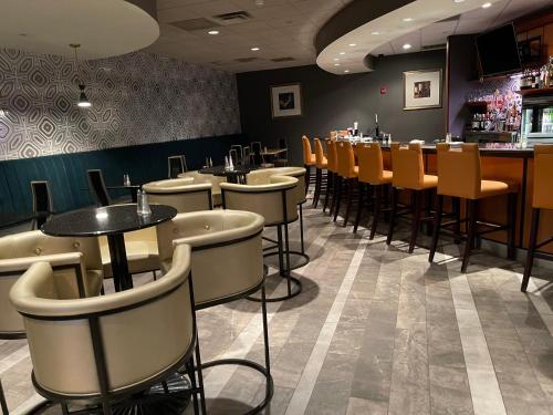 a restaurant with a row of tables and chairs at Holiday Inn Martinsburg by IHG in Martinsburg