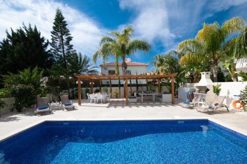 a swimming pool in front of a villa at Villa Helena in Ayia Napa
