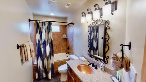 a bathroom with a sink and a toilet and a mirror at Arches East #389 in Moab