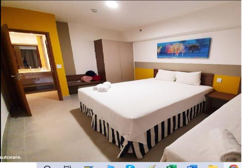 a bedroom with two beds and a person laying on the floor at Enjoy Olímpia Park Resort in Olímpia