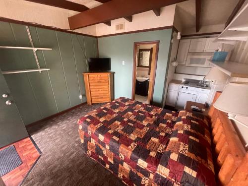 a bedroom with a bed and a kitchen at Olde Mill Inn of Clarkston in City in the Village of Clarkson