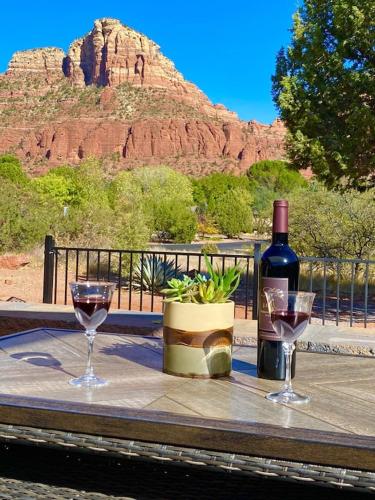 a table with two glasses and a bottle of wine at Beautiful Sedona Home Near Chapel of the Holy Cross in Sedona