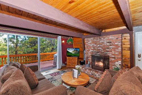 a living room with a couch and a fireplace at 070 - Tree Top Villa in Big Bear Lake