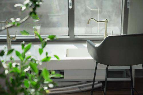 a black chair sitting in front of a window at Sancheong Korean Medicine Family Hotel in Sancheong