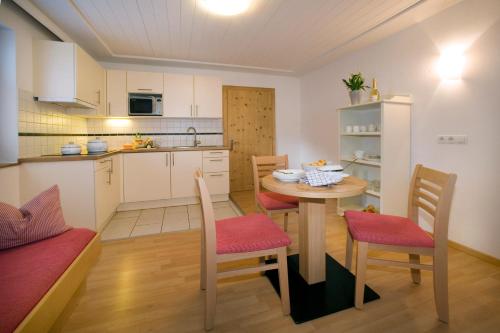 a kitchen and dining room with a table and chairs at Michi's Appartements in Gerlos
