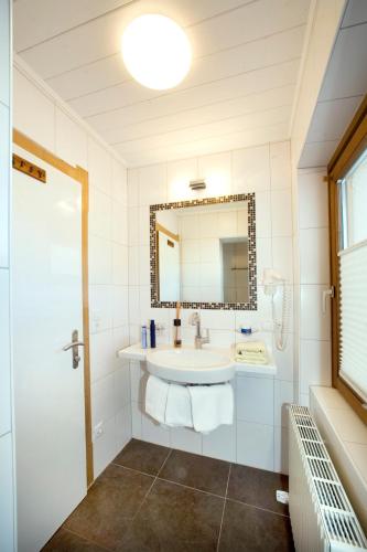 a bathroom with a sink and a mirror at Michi's Appartements in Gerlos
