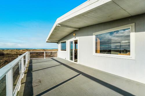 a balcony of a house with a view of the ocean at Copalis Beach Hideaway in Copalis Beach