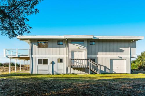 a house with a porch and a garage at Copalis Beach Hideaway in Copalis Beach
