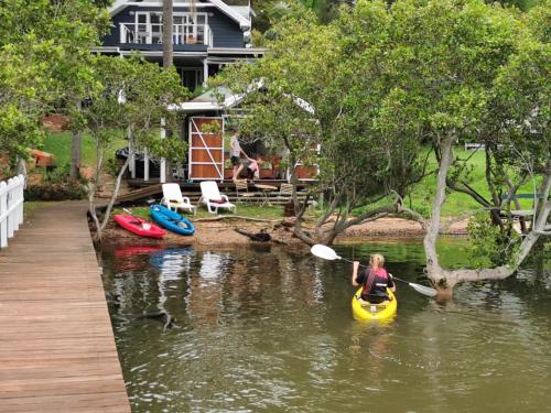 a woman in a yellow kayak in a river at Your Perfect Waterfront Escape in Bar Point