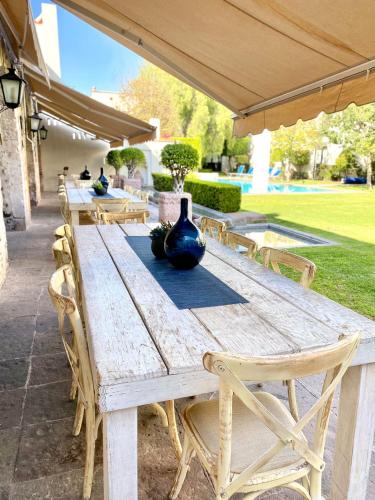 a wooden table with a vase sitting on top of it at Doña Urraca Hotel & Spa in Querétaro