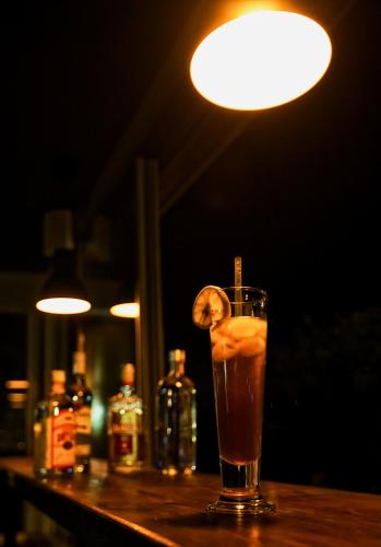 a drink on a bar with a lemon slice in it at Miro Mara Boutique Hotel & Lounge Bar in Edremit