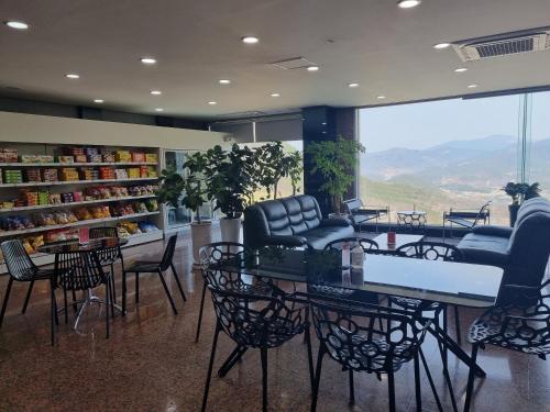 a store with chairs and tables in a room at Sancheong Korean Medicine Family Hotel in Sancheong