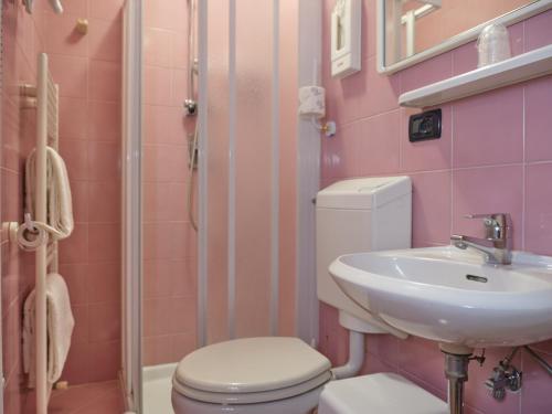 a pink bathroom with a toilet and a sink at Atlantide Hotel in Venice